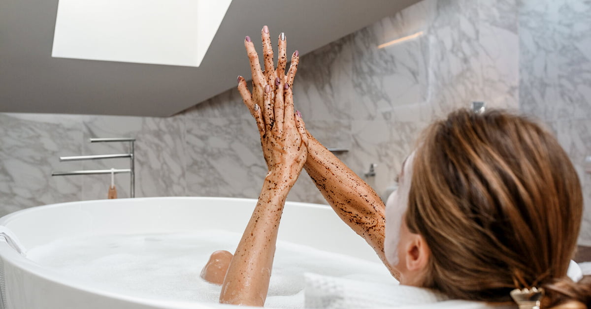 Sensual Woman Scrubbing Arms In Bath