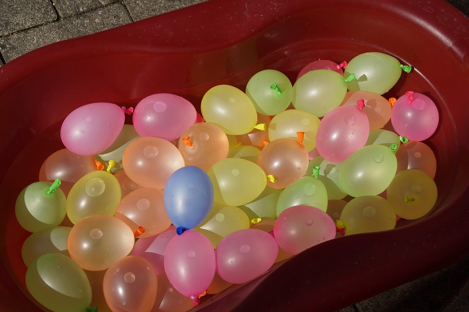A bucket filled with colorful balloons
