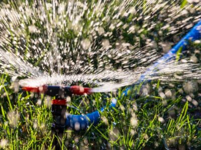 High-efficiency sprinkler watering lush green grass.