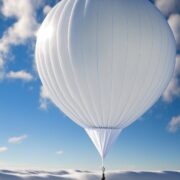 A white weather balloon soaring in the sky