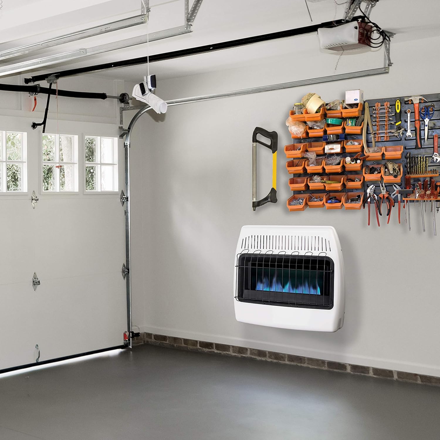 Garage with tools on wall and gas heaters