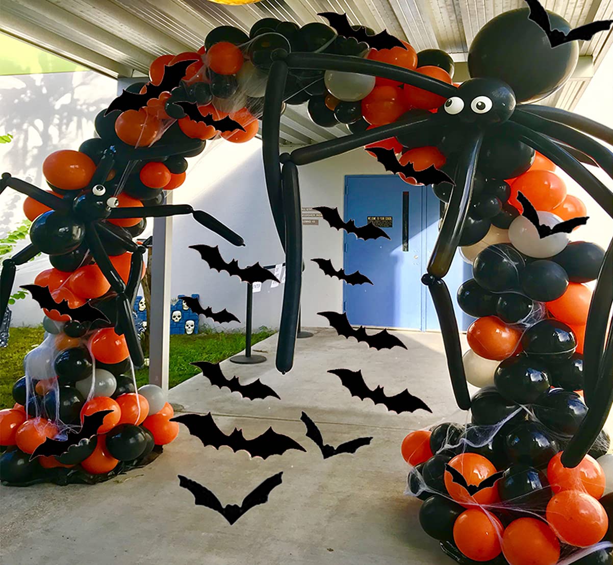 A spooky Halloween balloon arch with bats and spiders