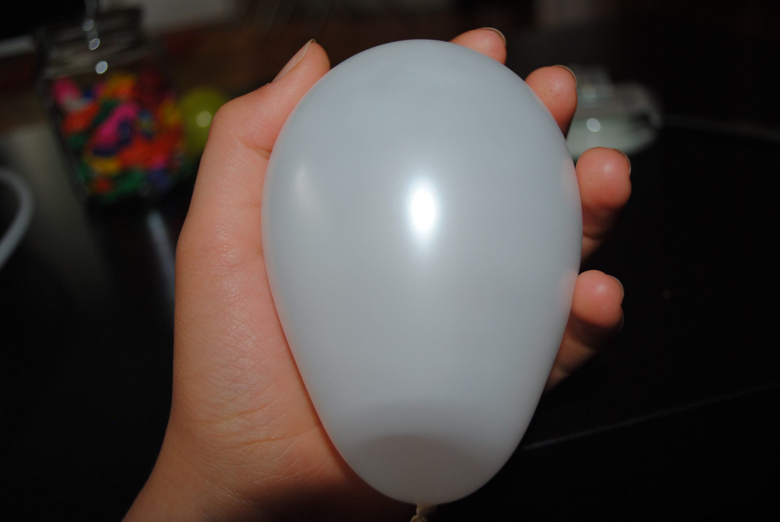 A person holding a white balloon