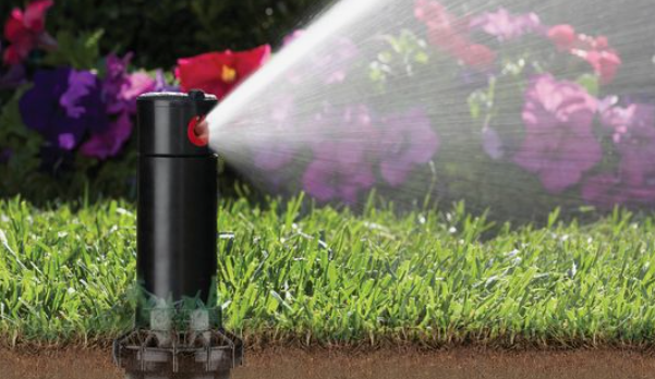 A sprinkler system watering a lawn
