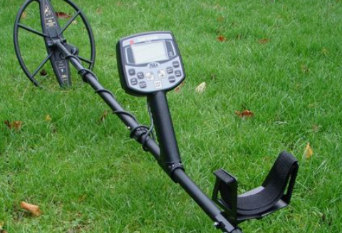  A metal detector resting on the grass