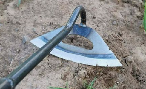 A hand shovel with a metal handle and blade