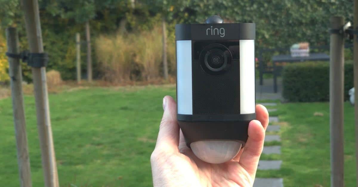 a hand holding ring security camera